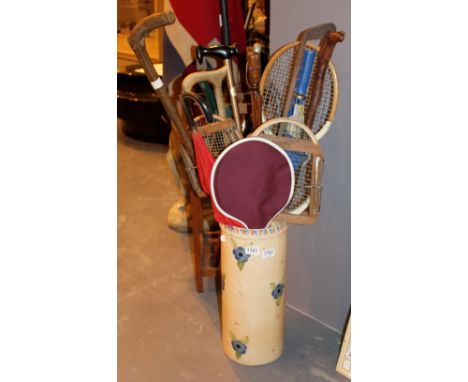 Ceramic stick stand with a quantity of walking sticks and other contents