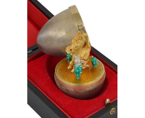 A Silver Gilt & Enamel Surprise Egg:By Stuart Devlin, London 1978, opening to reveal a donkey surrounded by cacti enamelled i