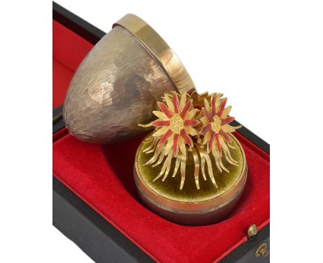 A Silver Gilt & Enamel Surprise Egg:By Stuart Devlin, London 1980, opening to reveal a cluster of asters on a lime green base