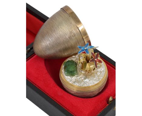 A Silver Gilt & Enamel Surprise Egg:By Stuart Devlin, London 1975, opening to reveal a frog by the side of flowers, enamelled