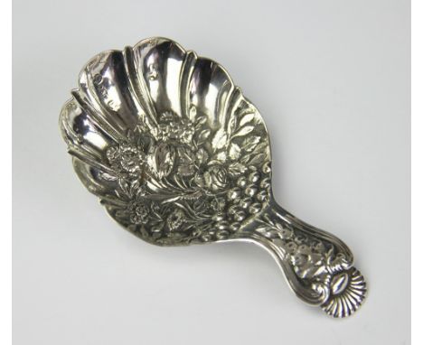 A 19th century silver caddy spoon, Joseph Willmore, Birmingham 1822, the embossed shell shaped bowl decorated with flowers, 7