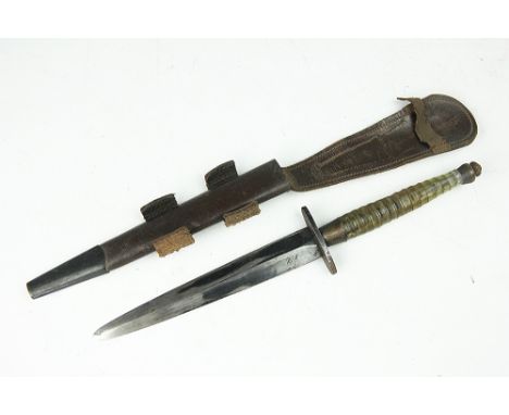 A World War II B2 Commando fighting knife, with unusual plexiglass segmented grip, stamped with a military arrow followed by 