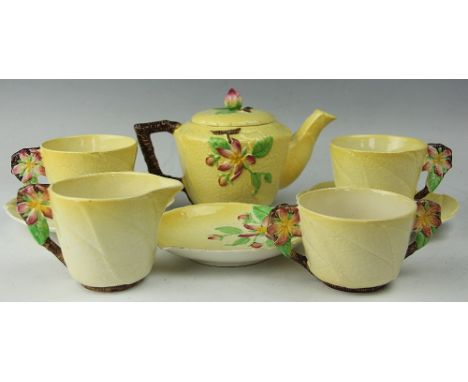 A Carltonware tea for two service, comprising teapot and cover, two cups and saucers, sugar bowl, jug and dish, each moulded 