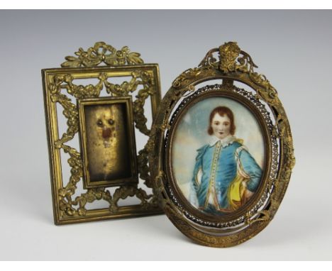 A 19th century oval portrait miniature depicting a gentleman in 17th century dress, signed to the right, within elaborate fra