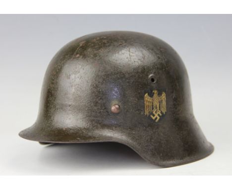 A WWII M35 NS64 type German Army/Heer single decal helmet, there are two stamped numbers, the one at the back of the helmet m