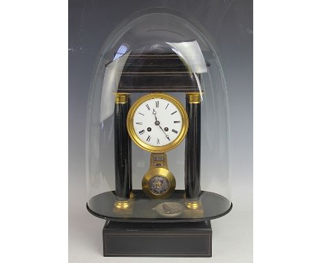 A 19th century French eight day ebonised portico clock, with enamel Roman numeral dial and movement striking on a bell, with 