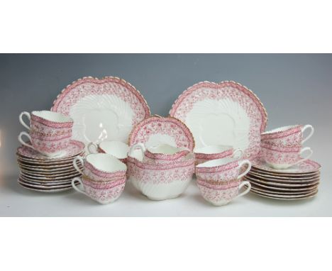 A Victorian part tea service, each quatrefoil shaped piece decorated with a Wileman & Co type design in a red palette with gi