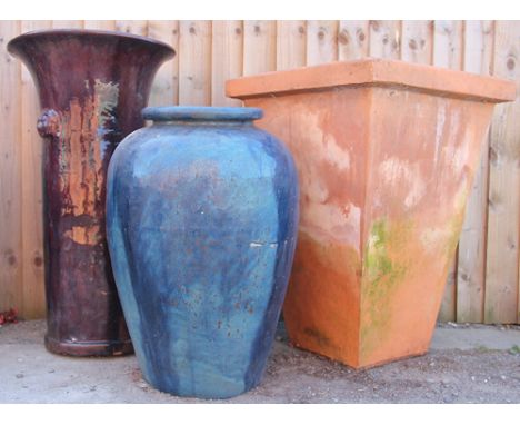 A selection of three garden vases/planters, comprising a large ovoid  blue glazed example, 63cm high, a Chinese style iridesc