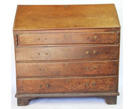 A George III oak bureau, with fall enclosing a fitted interior, above four long drawers, on bracket feet, 101cm H x 101cm W x
