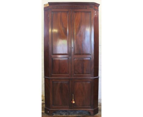 A 19th century mahogany corner cabinet, with moulded cornice above four panelled doors, on bracket feet, 219cm H x 113cm W (P