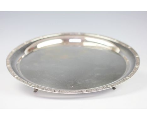An Irish silver salver, Jewellery and Metal Manufacturing Co, Dublin, 1973, with Celtic strap work rim on dolphin feet, 29.5c