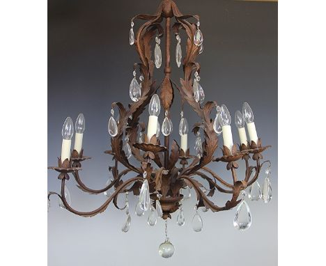 A modern Louis XV style bronzed metal eight light chandelier decorated throughout with scrolling acanthus leaves and faceted 