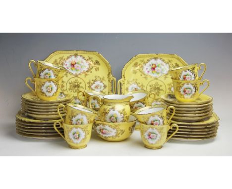 A Noritake fourty piece tea service, early 20th century, each piece decorated with a panel of blossoms within scrolling gilt 