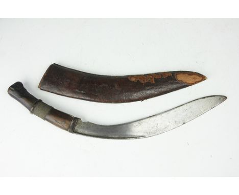 A Gurkha Kukri knife, possibly late 19th century, with 31cm blade and wire bound wood grip, in leather mounted scabbard (2)