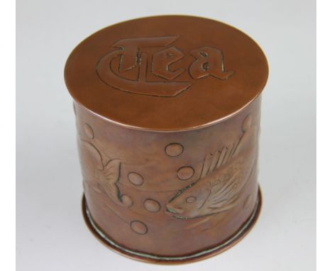 A Newlyn copper circular tea caddy, relief decorated with fish amongst seaweed below a cover titled 'Tea', impressed 'Newlyn'