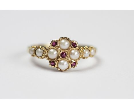 A Victorian style split seed pearl and ruby set ring in 14ct gold, designed as a central circular cluster and with further pe