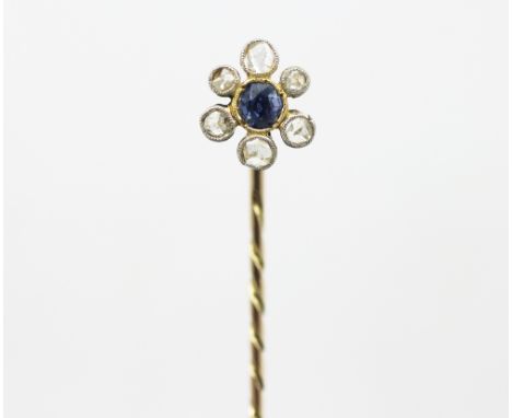 A sapphire and diamond cluster set stick pin, designed as a central sapphire within a surround of six rose cut diamonds, each