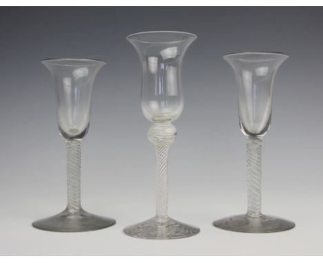 A near pair of 18th century style double opaque twist wine glasses, with flared bowls, 15cm, with a taller single opaque twis