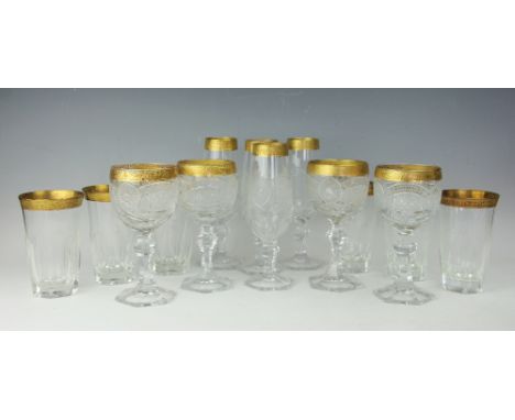 A part suite of gilt decorated and cut glass glasses, comprising; four wine glasses, 18.5cm high, and four champagne flutes, 