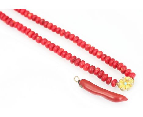 A stick coral coloured pendant 5.5cm long and a coral coloured bead necklace 67cm long with later gilt metal clasp (2) 