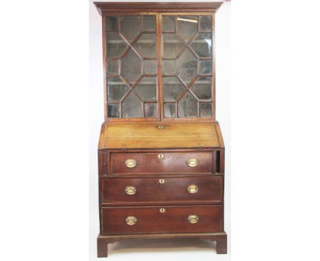 A George III oak bureau bookcase, with two astragal glazed doors above a fall enclosing a fitted interior, on bracket feet, 1