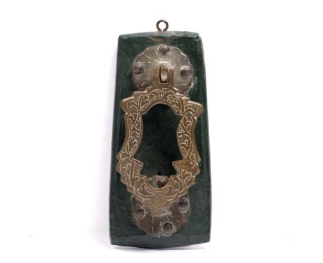 Door knocker Islamic, 19th Century decorated with a simple scroll pattern, attached to a wooden base 18cm high