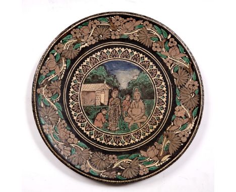 Ceramic plate Indian, late 19th Century in the Bombay School of Art style, depicting a centre scene of a family in the forest