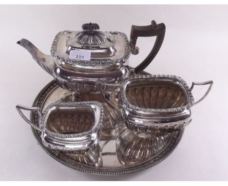 A silver plated three piece tea service on silver plated circular tray
