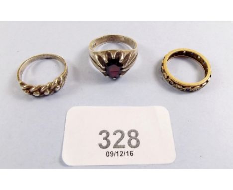 A yellow metal eternity ring and two silver rings 