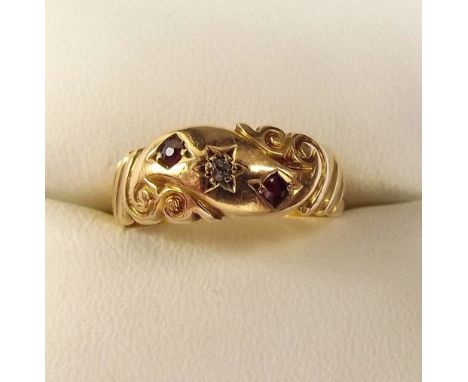 An 18ct gold ring set rubies and chip diamond 