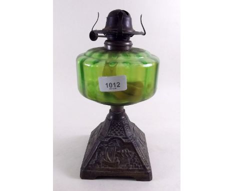 A Victorian oil lamp with green glass reservoir 