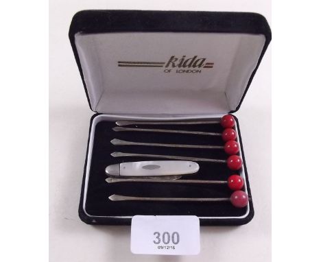 A set of six silver cocktail sticks (one bead replaced) and a silver and mother of pearl fruit knife 