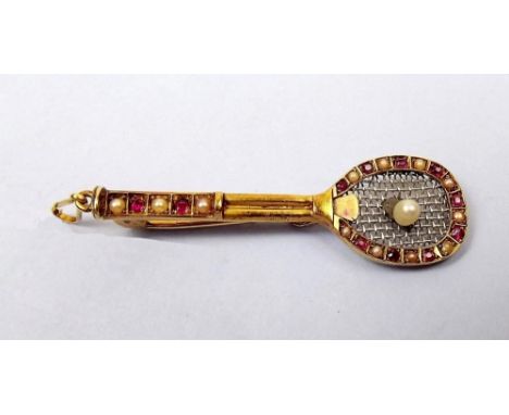 An Edwardian 15 ct gold ruby and pearl set tennis racquet brooch