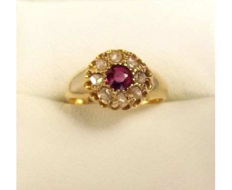 An 18 carat gold ruby and diamond cluster ring