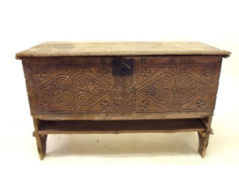 An early 17th century primitive coffer with stylised foliage and scrollwork decoration to front and ends, monogrammed 'EH' an