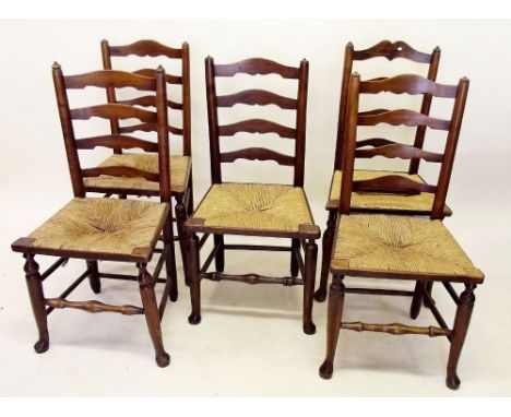 A matched set of five 18th century ladder back chairs with rush seats, spindle stretcher and pad feet