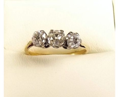 An 18ct gold three stone diamond ring 