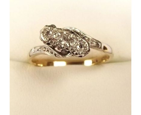 A 9ct gold illusion set three stone diamond crossover ring 