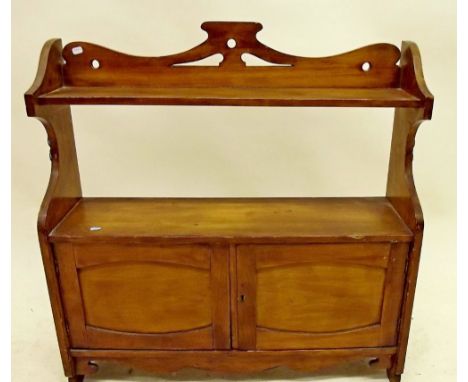 An Edwardian wall shelf with cupboard 