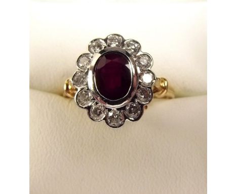 An 18 carat gold ruby and diamond cluster ring