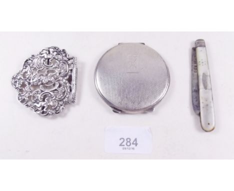 A silver compact, a silver and mother of pearl penknife and a silver buckle 