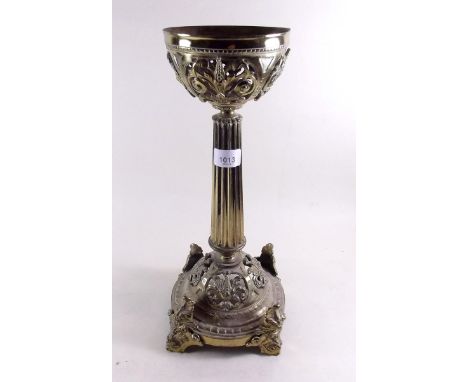 A Victorian brass base for an oil lamp with scrollwork and foliage decoration