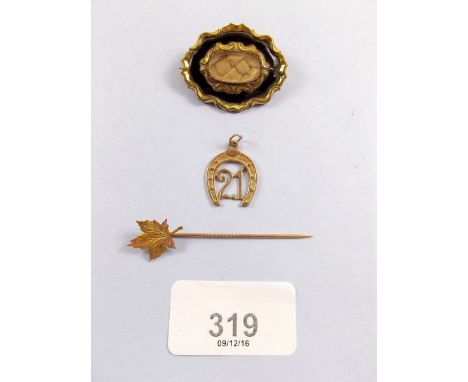 A 10k maple leaf stick pin, a 9ct gold '21' pendant and a yellow metal mourning locket (3g total gold) 