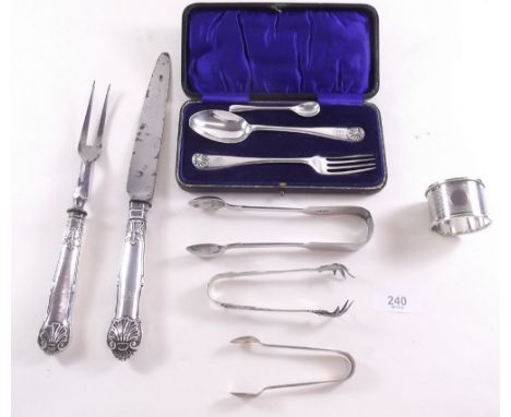 A silver spoon and fork christening set boxed, silver handled carving set, three pairs of silver sugar tongs, napkin ring etc