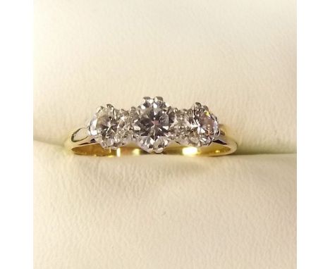 A gold three stone diamond ring 