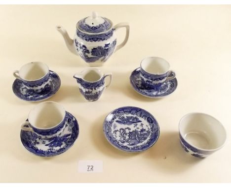 A blue and white childs tea service comprising: three cups and four saucers, teapot, milk and sugar 