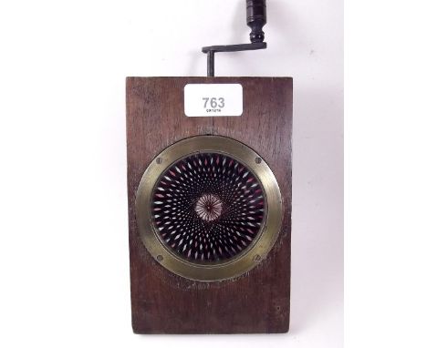 A Victorian kaleidoscope magic lantern slide with winding handle