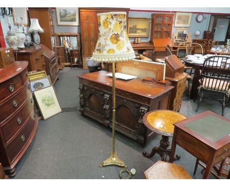 A brass standard lamp with floral design shade
