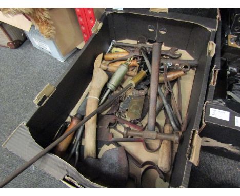 A box of bygone tools including clippers and cleaver