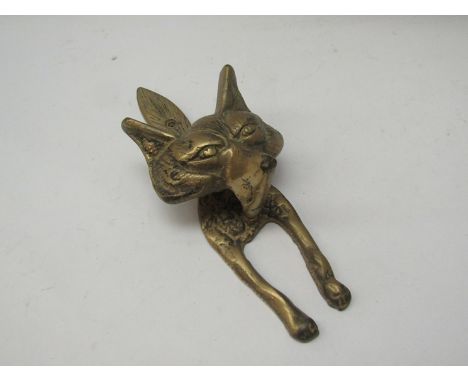 A brass door knocker in the form of a fox